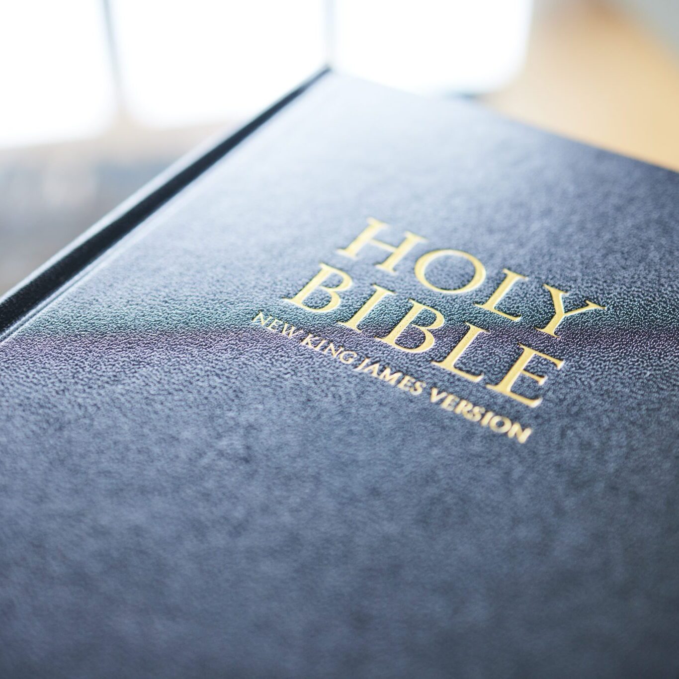 Closeup, bible book and home for faith, studying religion and mindfulness with holy spiritual scrip.